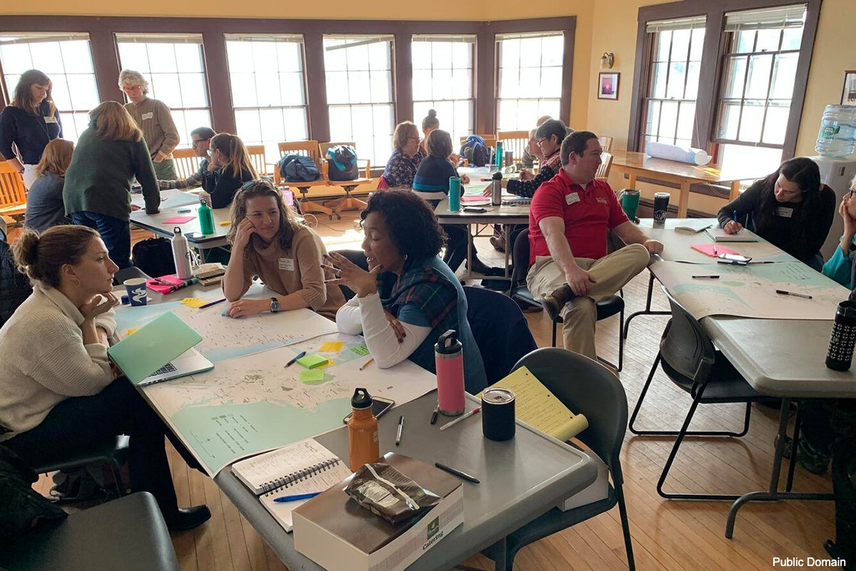 A photo of a people working in small groups