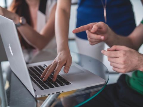 Image showing people working on a computer.