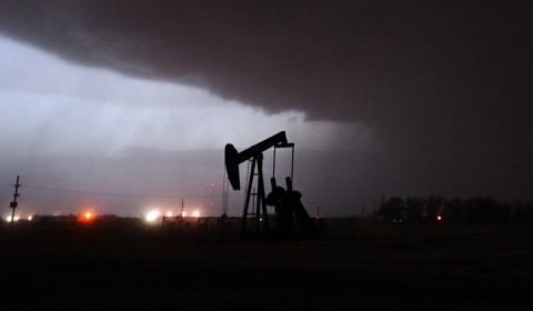 A photo showing an oil rig in a thunder storm. 