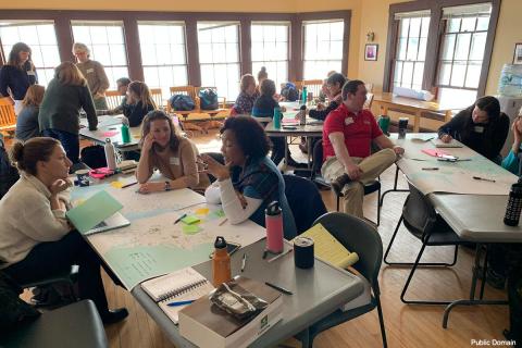A photo of a people working in small groups